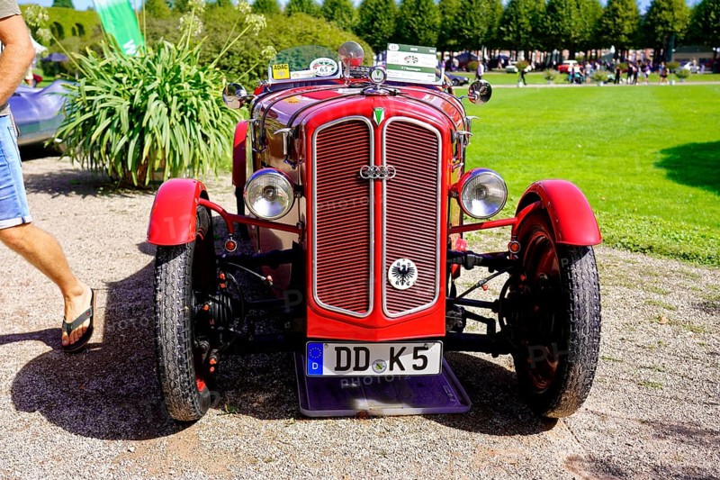 DKW, year of construction 1938, Oldtimer Classic, Gala International Concours d'Elegance Schwetzingen 2025, Germany, Europe, Red classic car in front view on a gravel path with green garden in the background