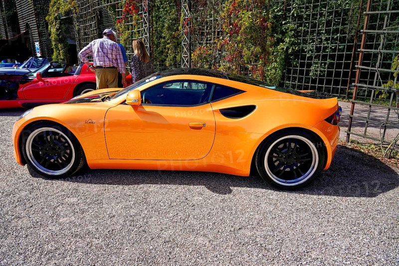 Artega, year of construction 2011, Oldtimer Classic, Gala International Concours d'Elegance Schwetzingen 2025, Germany, Europe, side view of an orange Artega sports car, surrounded by people in the sunshine