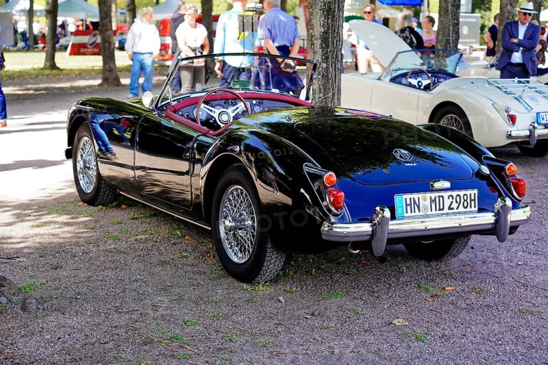 Oldtimer Classic, Gala International Concours d'Elegance Schwetzingen 2025, Germany, Europe, A black convertible vintage MG in a park with people in the background