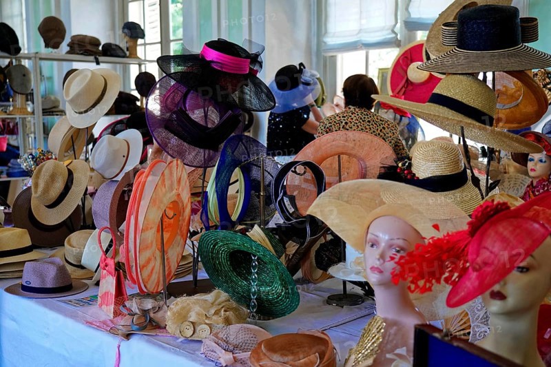 Oldtimer Classic, Gala International Concours d'Elegance Schwetzingen 2025, Germany, Europe, A table full of fashionable hats in different colours displayed in a shop