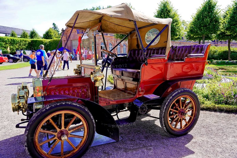 Oldtimer Classic, Gala International Concours d'Elegance Schwetzingen 2025, Germany, Europe, A red antique car with an open top stands in the sun in a historic park
