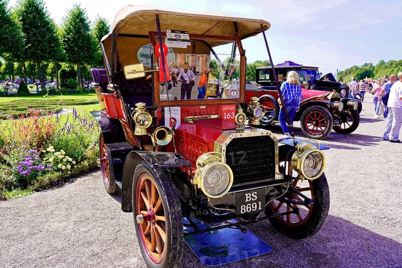 Oldtimer Classic, Gala International Concours d'Elegance Schwetzingen 2025, Germany, Europe, A red vintage car at a sunny event, surrounded by people and trees
