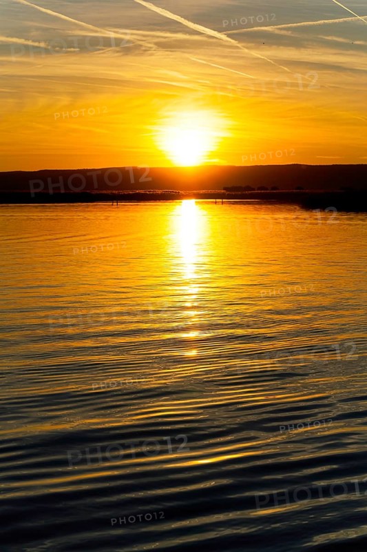 Lake Neusiedl, Burgenland, Austria, Europe, A magnificent sunset is reflected in the calm waters, Sailing boats on Lake Neusiedl