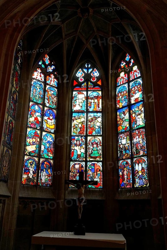 The interior of the largest Protestant church in Germany. It has the world's highest church tower, Ulm Minster, Germany, Europe, Gothic stained glass windows with a cross in the foreground in a church interior, Ulm