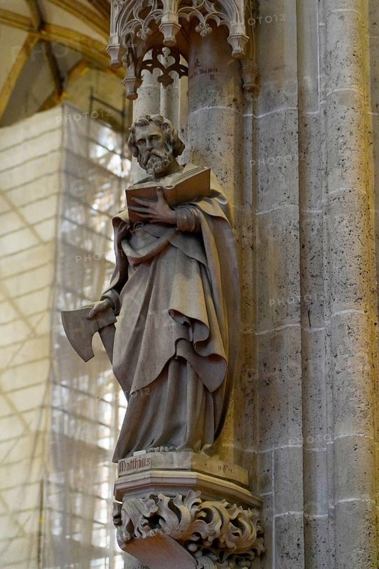 The interior of the largest Protestant church in Germany. It has the world's highest church tower, Ulm Minster, Germany, Europe, Stone statue of a saint with a book on a Gothic column, Ulm