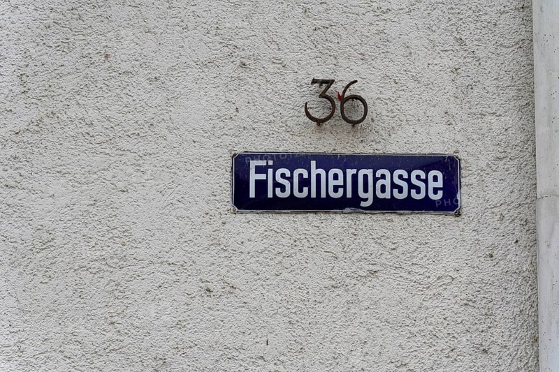 The picturesque fishermen's quarter in Ulm with its beautiful half-timbered houses on the Blau river, alleyway sign 'Fischergasse' with house number on a white wall, Ulm, Germany