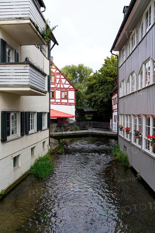 The picturesque fishermen's quarter in Ulm with its beautiful half-timbered houses on the Blau, a small river flowing between half-timbered houses in an idyllic old town, Ulm, Germany