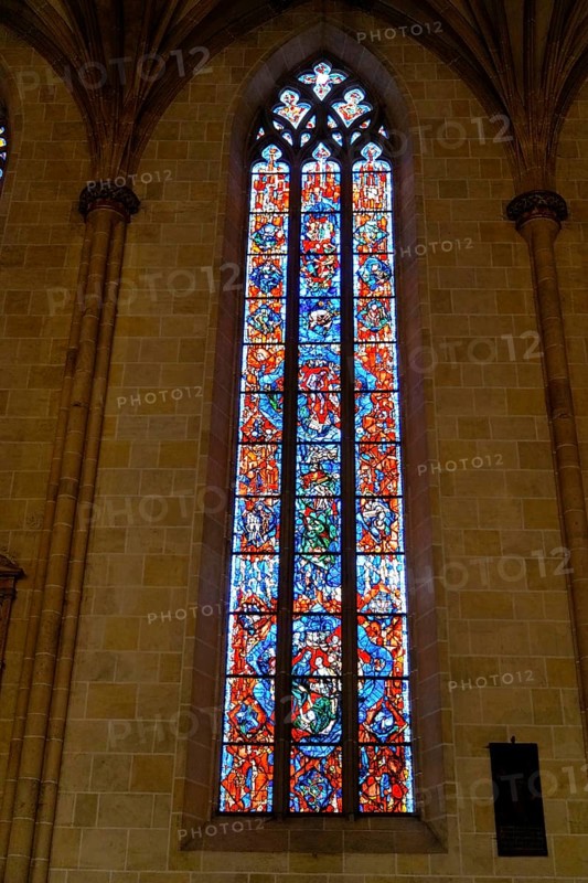 The interior of the largest Protestant church in Germany. It has the world's highest church tower, Ulm Minster, Germany, Europe, High, richly decorated stained glass window in a colourful design, Ulm