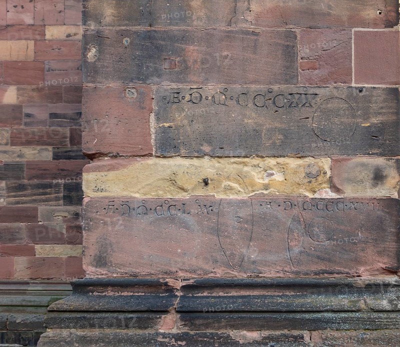 Historic engravings on a stone wall at the Freiburg Minster in Freiburg im Breisgau, a city in southern German