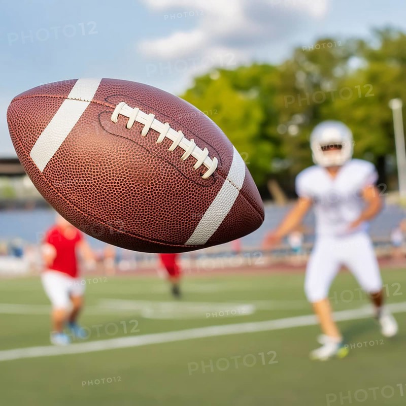 AI generated image showing a rugby scenery with ball closeup on a playing field with players