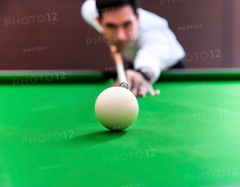 AI generated image showing a billiards table closeup with player and cue ball