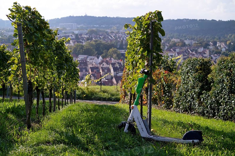 E-scooter, electric scooter, scooter parked in the vineyard next to vines, in the bike rental of the company Lime, OnLime and Uber, Bad Cannstatt, Stuttgart, Baden-Württemberg, Germany