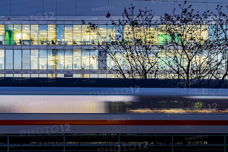Office building at night. In front of it a passing ICE train of Deutsche Bahn AG. Stuttgart, Baden-Württemberg, Germany