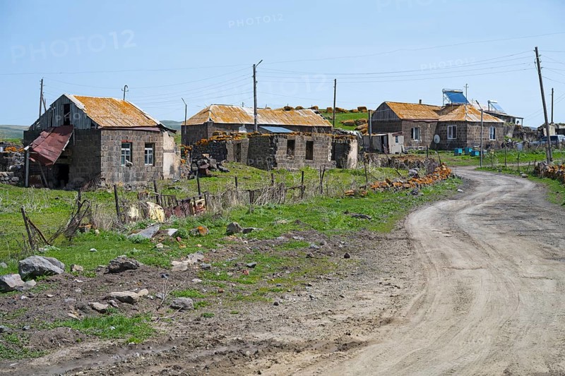 Quiet village with old buildings along a dirt road in a green landscape, Berdashen, Lake Arpi, Shirak Province, Armenia