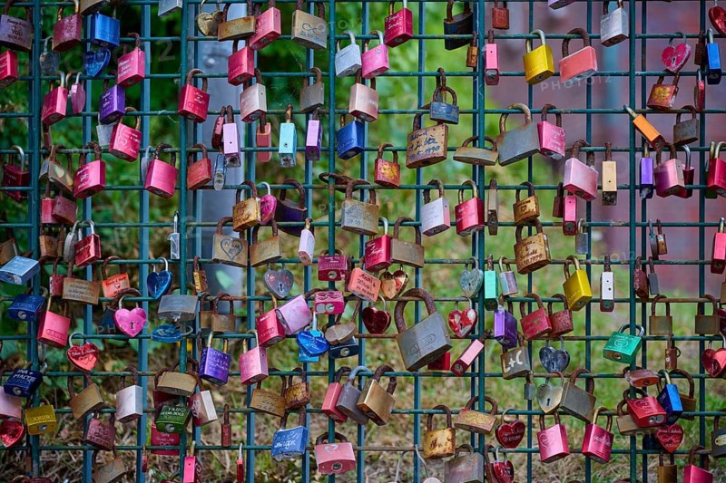 Colourful love locks on an outdoor fence, Laboe, Kiel Fjord, Schleswig-Holstein, Germany