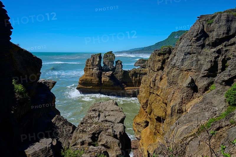 Rocky cliffs overlooking the sea under a clear blue sky, Pancake Rocks, Westport, Greymouth, West Coast, South Island, New Zealand