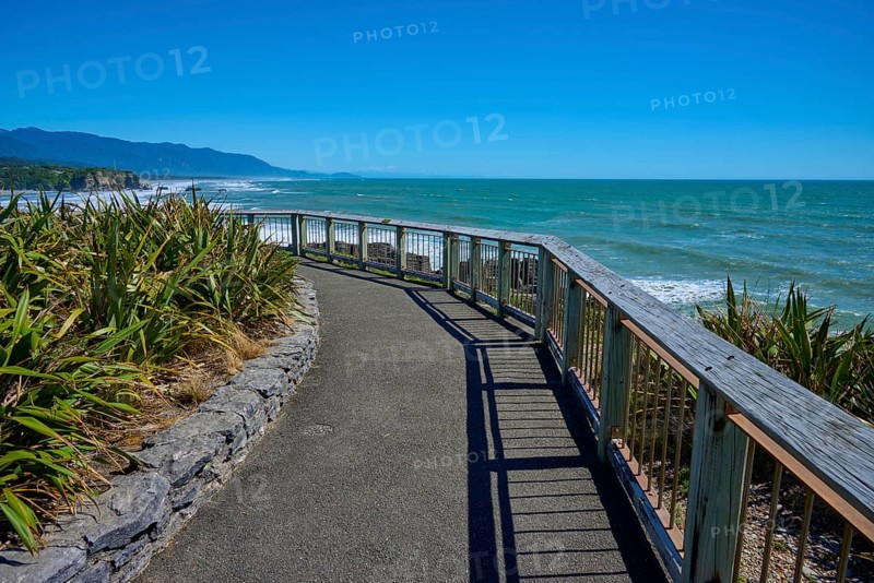 A walkway with railings offers a wide view over the sea and the coastline, Pancake Rocks, Westport, Greymouth, West Coast, South Island, New Zealand