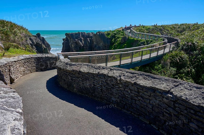 Extensive stone paths lead over a bridge past cliffs overlooking the sea, Pancake Rocks, Westport, Greymouth, West Coast, South Island, New Zealand