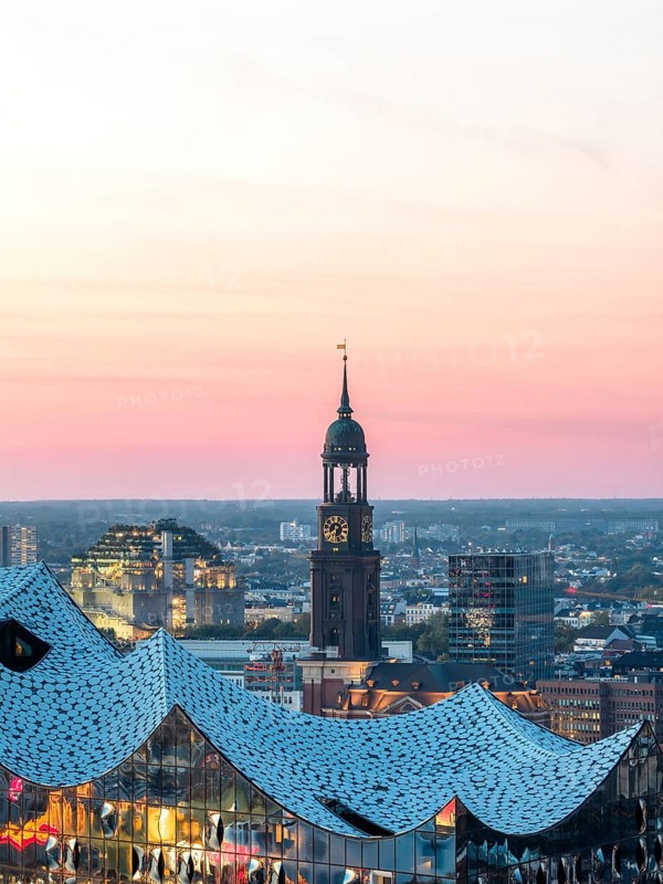 Aerial view of the Elbphilarmonie with St Michael's Church and Hamburg Bunker in the background at blue hour, Hamburg, Germany