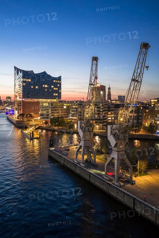 Aerial view of the Elbphilharmonie with Sandtorkai and historic cranes at the blue hour, Hamburg, Germany