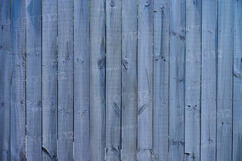 Close-up of a grey wooden fence with vertical panels and distinct texture, West Coast, South Island, New Zealand