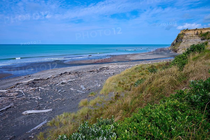 Wide coastal view with imposing cliffs, calm sea and cloudy sky, Mana Bay, Riverview Lookout, Patea, Taranaki, North Island, New Zealand