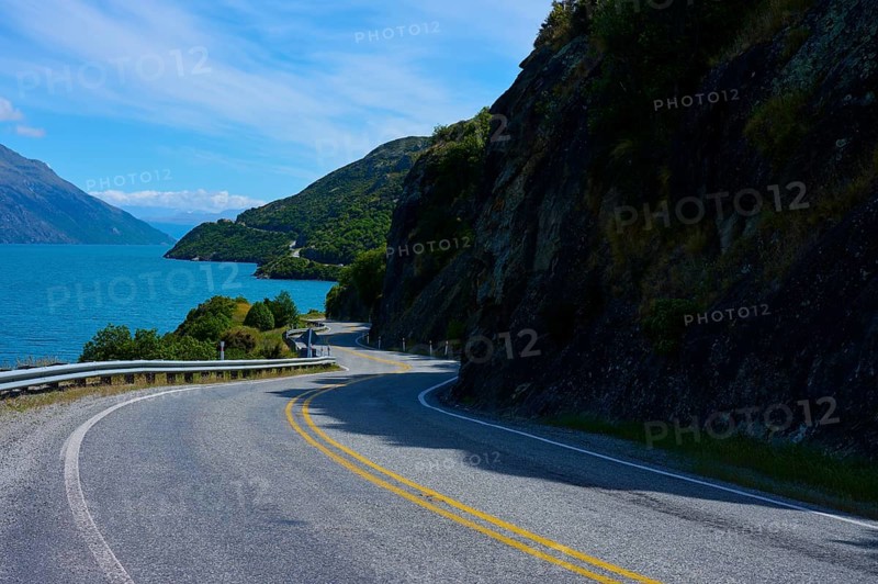 Winding road leads through remote landscape along a lake, Devil's Staircase Lookout Point, Kingston, Lake Wakatipu, Queenstown-Lakes District, Otago, South Island, New Zealand
