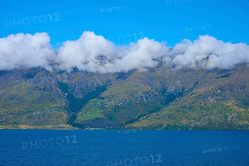 Mountains with a wreath of clouds over a blue lake under a clear sky, Drift Bay, Lake Wakatipu, Queenstown-Lakes District, Otago, South Island, New Zealand