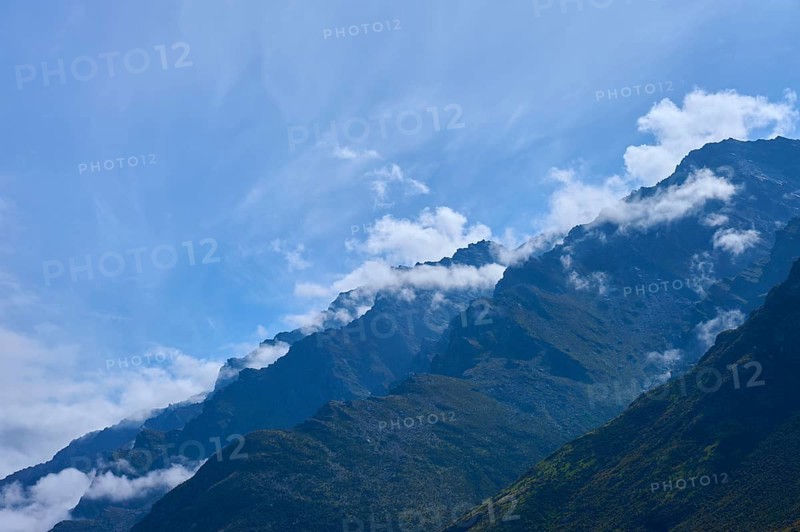Mountain peak in the foreground with white clouds in the sky, Drift Bay, Lake Wakatipu, Queenstown-Lakes District, Otago, South Island, New Zealand