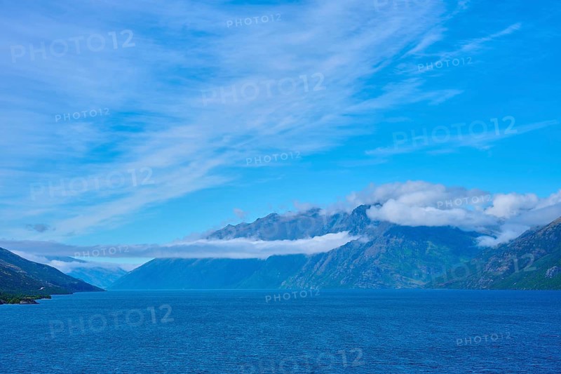 Tranquil landscape with mountains, blue lake and slightly cloudy sky, Drift Bay, Lake Wakatipu, Queenstown-Lakes District, Otago, South Island, New Zealand