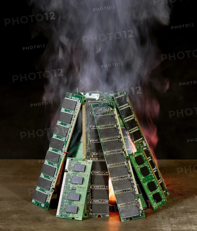 Pile of random access memory sticks and flame in front of dark back