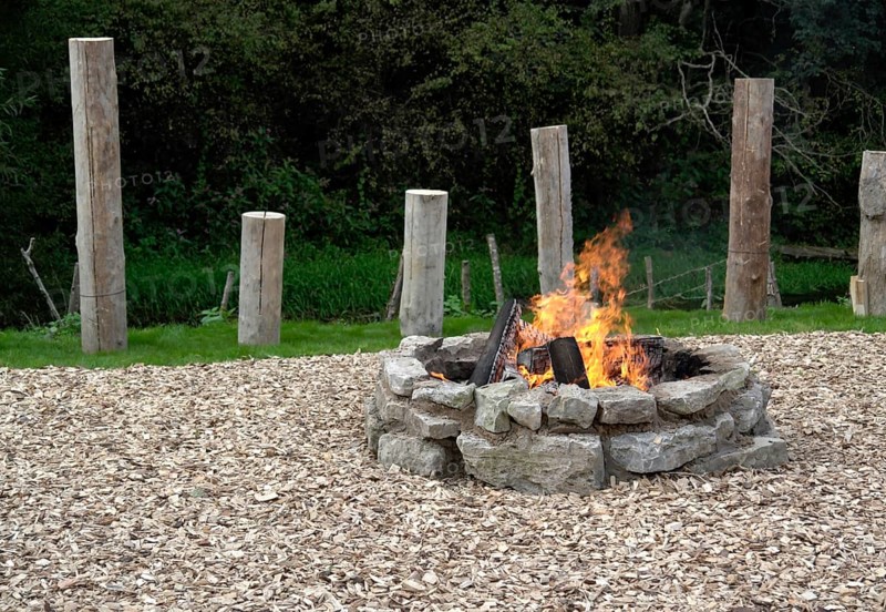Outdoor fireplace with burning fire