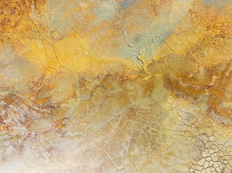 Abstract patterns in a waste pond in the mineral-rich area of the Rio Tinto mines. The colour is caused by oxidised iron minerals. Aerial view. Drone shot. Huelva province, Andalusia, Spain