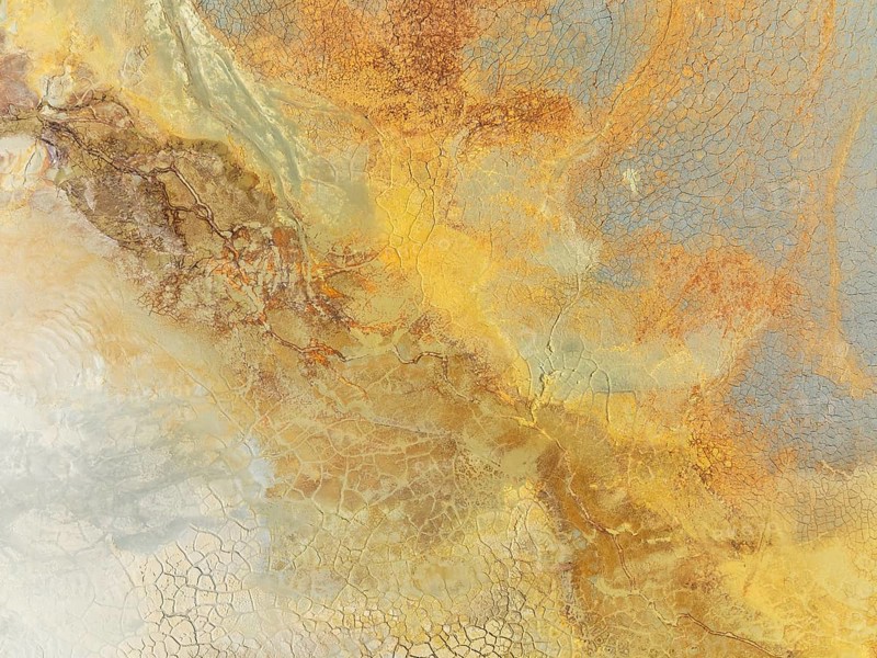 Abstract patterns in a waste pond in the mineral-rich area of the Rio Tinto mines. The colour is caused by oxidised iron minerals. Aerial view. Drone shot. Huelva province, Andalusia, Spain