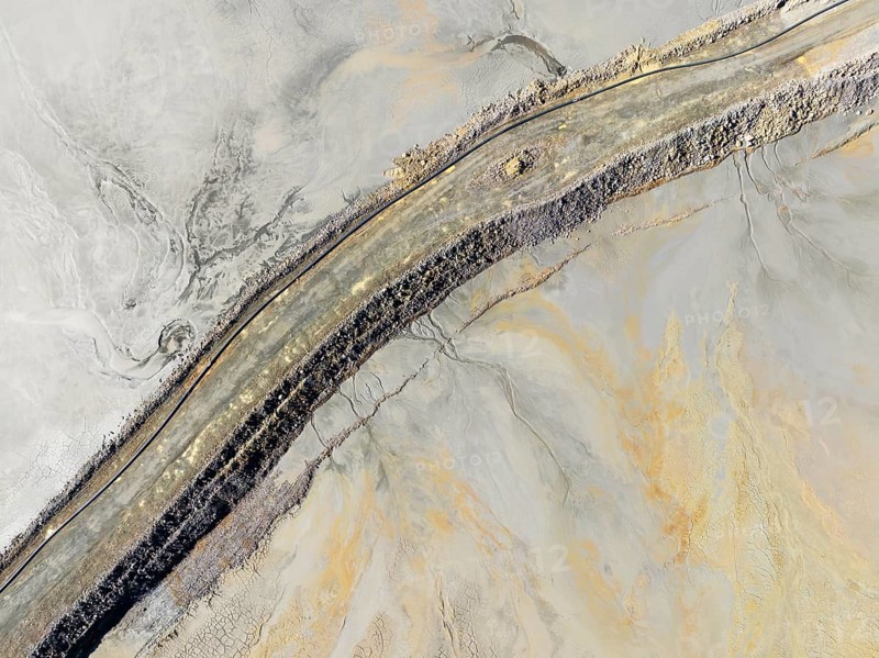Causeway at a waste pond in the mineral-rich area of the Rio Tinto mines. Aerial view. Drone shot. Huelva province, Andalusia, Spain