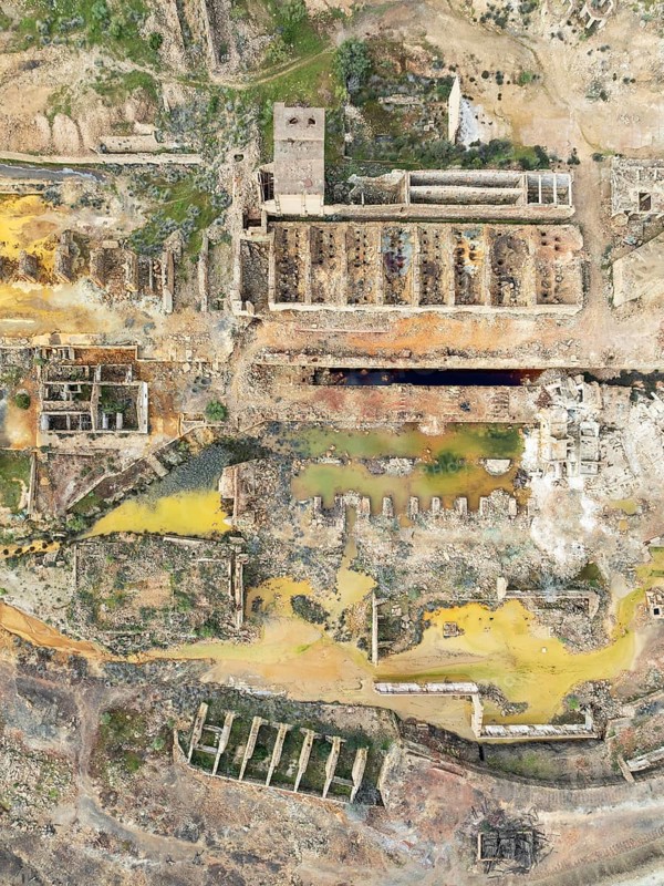 Old mining site and deep orange-red hues in the water of a pool in the mineral-rich area of the Rio Tinto mines. The colour is caused by oxidised iron minerals. Aerial view. Drone shot. Huelva province, Andalusia, Spain