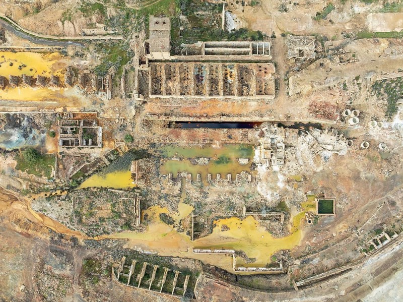 Old mining site and deep orange-red hues in the water of a pool in the mineral-rich area of the Rio Tinto mines. The colour is caused by oxidised iron minerals. Aerial view. Drone shot. Huelva province, Andalusia, Spain