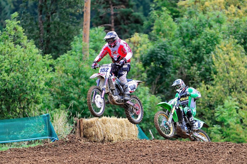 Motocross, Rudersberg, Baden-Württemberg, Germany, Europe, Two motocross riders jump over a mound of earth, trees in the background, Rudersberg motocross