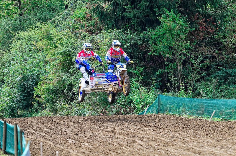 Motocross, Rudersberg, Baden-Württemberg, Germany, Europe, Two riders with sidecars jump over a dirt track surrounded by green trees, Rudersberg motocross