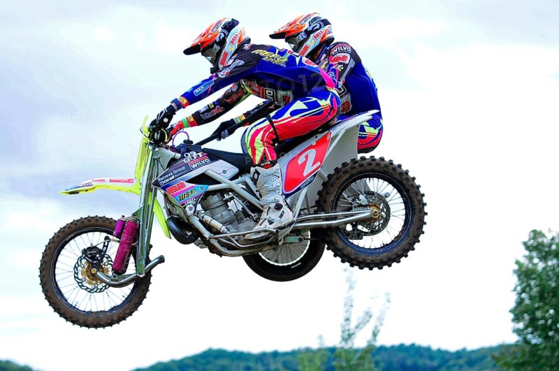 Motocross, Rudersberg, Baden-Württemberg, Germany, Europe, Two motorbike racers in colourful suits jumping over a race track, Rudersberg motocross