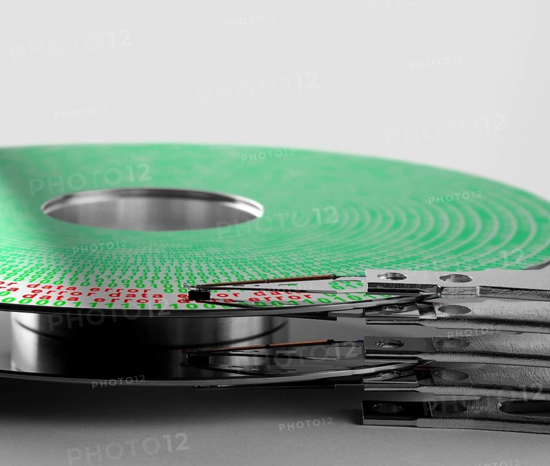 Detail shot of a hard disk platter with actuator arm and symbolic data error processing