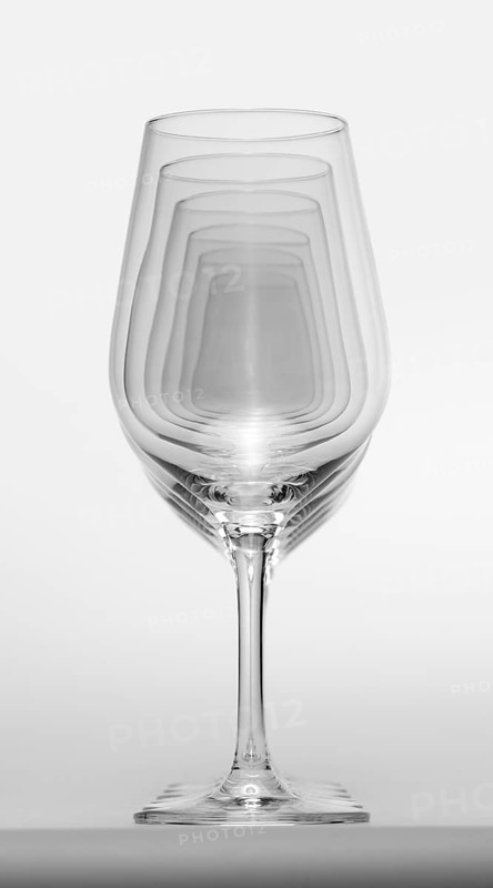 Some clean and empty wine glasses standing in a row in light grey back