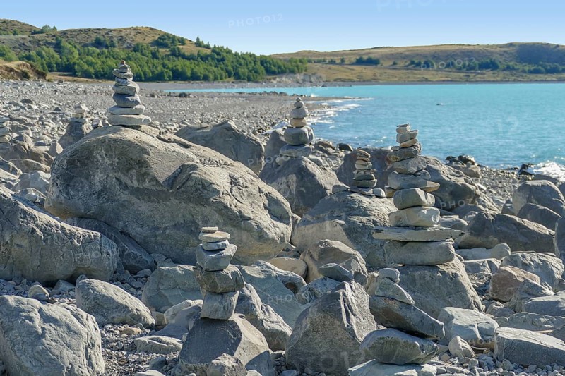 Coastal scenery with stone piles seen around Lake Pukaki at the South Island of New Zealand