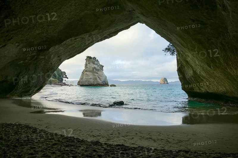 Te Hoho Rock seen through a rock arch at a coastal area named Cathedral Cove in the southern part of Mercury Bay on the Coromandel Peninsula at the North Island of New Zealand