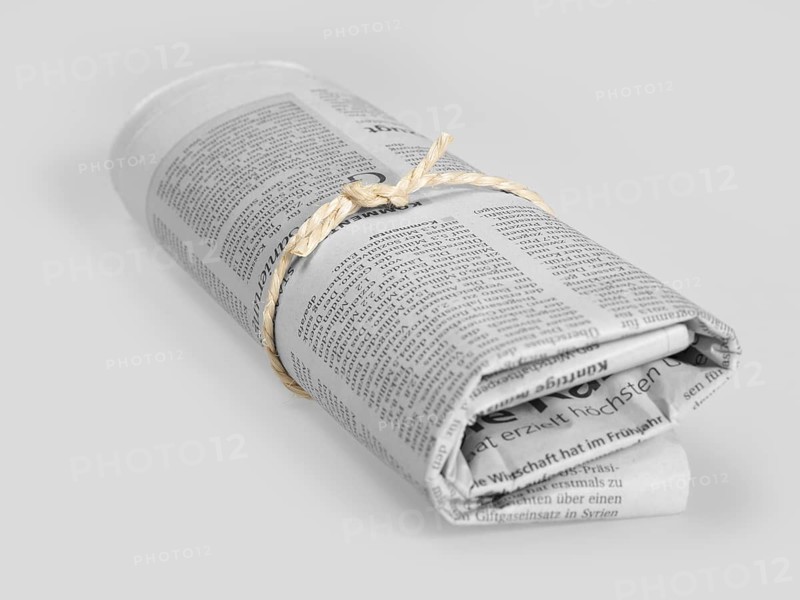 Rolled german newspaper in grey back