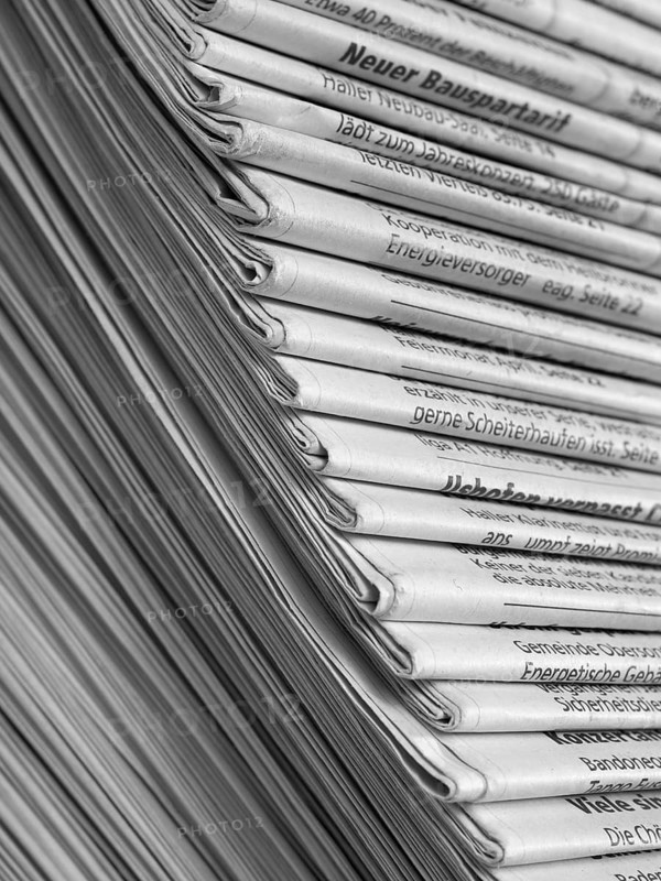 Full frame background with lots of stacked newspapers