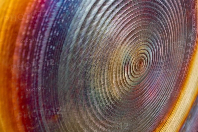Full frame abstract closeup shot of a colorful metallic asian gong