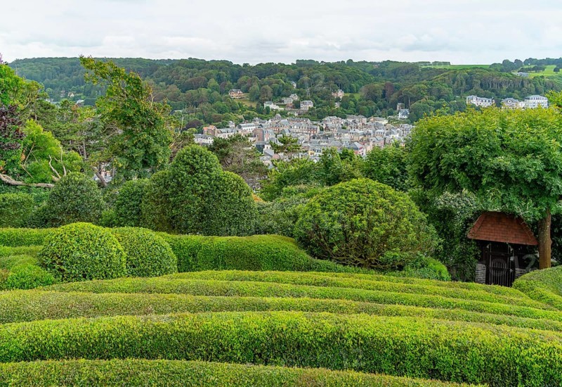Idyllic garden scenery with green trees, bushes and hedges at summer time seen around Etretat in Normandy, France