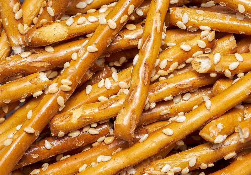 Full frame closeup of some baked sesame sticks