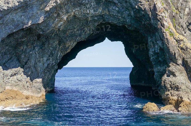 Sunny scenery showing a rock gate at the Bay of Islands, an area on the east coast of the Far North District of the North Island of New Zealand